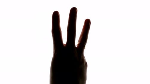 Hand showing three point sign on a white chroma key screen, closeup