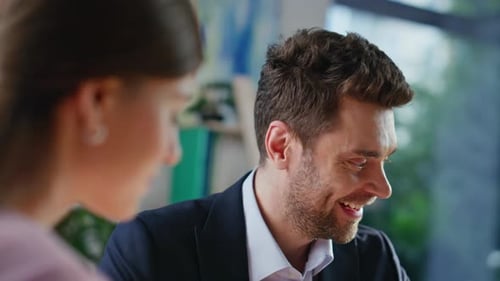 Man Shakes Hand with Woman in Office Meeting