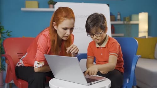 Teacher and Student Use Laptop for Learning