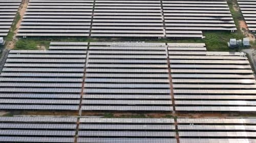 Aerial outdoor solar panel farm with aligned rows