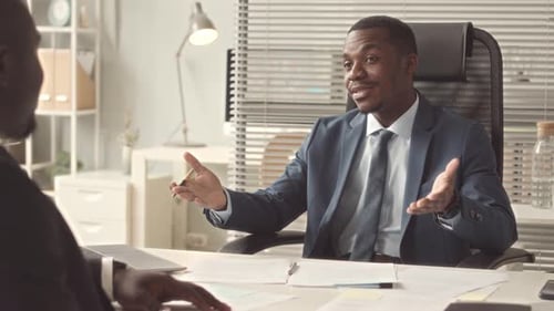 Businessmen Discussing Documents at Office Desk