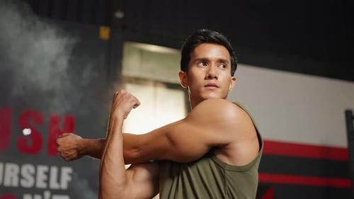 Portrait of Asain sportsmale shirtless exercising in fitness gym club.