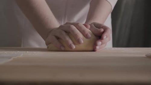 Woman Hands Close Up Kneading Dough on Floured Table Preparing Home Made Sourdough Wheat Bread