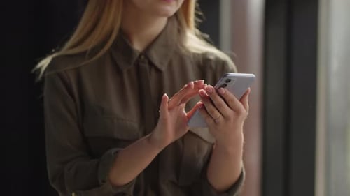 Cropped View of Woman Tapping and Sliding on Smartphone Screen Blonde Woman Browsing Social Media