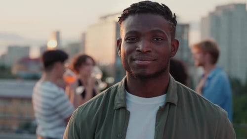 Smiling Young Adult With Friends on Rooftop