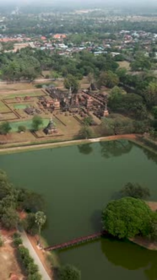 A Buddhist Monument Surrounded By Water is Seen From the Sky