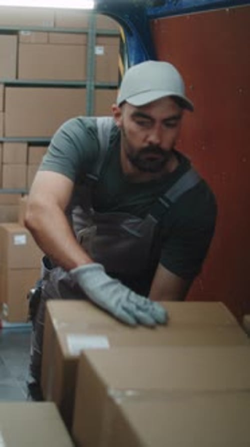 Multiethnic Workers Loading Cardboard Boxes in Delivery Truck From Logistics Retail Warehouse