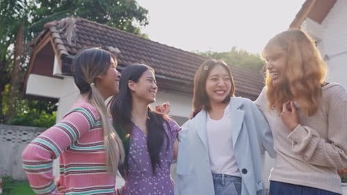 Four Young Adults Laughing Together Outdoors