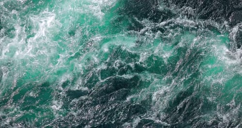 Blue waves of water of the river and the sea meet each other during high tide and low tide.
