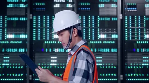 Asian Male Use Tablet While Walking in Data Center