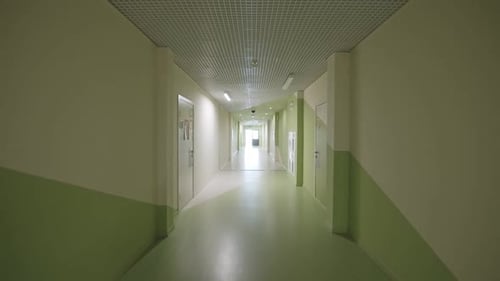 Walking Along Hallway with Pastel Color Walls in School
