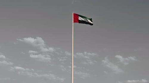 Colour Splash Effect: Flag of the United Arab Emirates waving in the air cloudy Blue sky in Backgrou