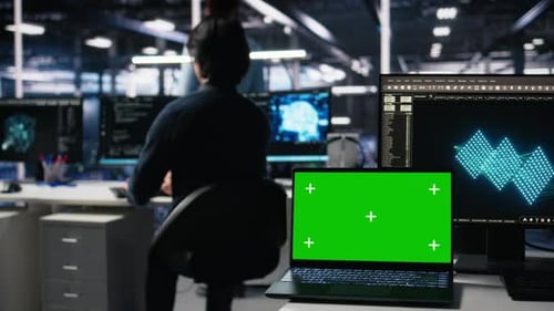 Engineer in Data Center Coding with Generative AI Assistance on Chroma Key Laptop