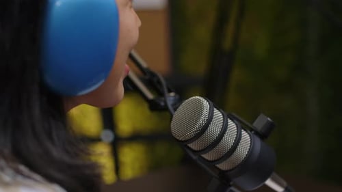 Female Blogger Recording Audio Podcast in Studio