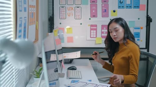 Young Woman Designing an App Interface at Desk