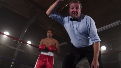 Boxing referee counts out boxer in slow motion sport competition