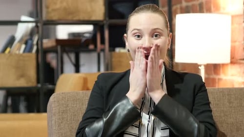 Woman Reacts with Surprise and Delight Indoors