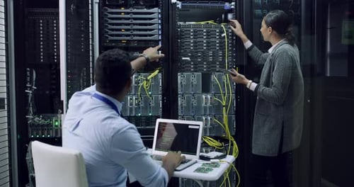 Technicians Working in Modern Data Center Server Room