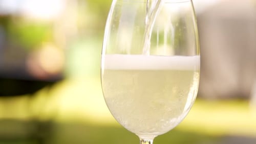 Sparkling White Wine Being Poured Into Glass