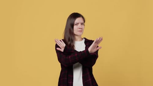 Woman Crossing Arms to Express Refusal