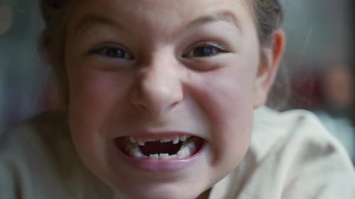 Girl Smiling with Missing Teeth in a Close Up