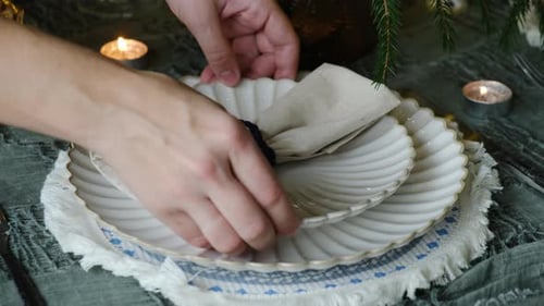 Decorative holiday table setting with plates and napkin