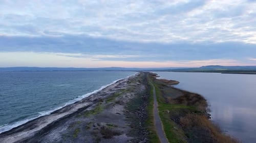 Bird's Eye View of Beach with Sand Grass and Stones Washed By Bay of Black Sea and Lake Under Sky in