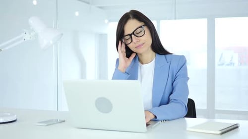 Business Woman Working on Laptop in Bright Office