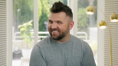 Man Smiles and Makes Silly Faces Indoors
