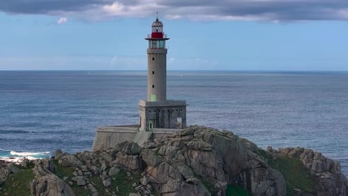 Lighthouse With Blue Sea in The Background In Galicia