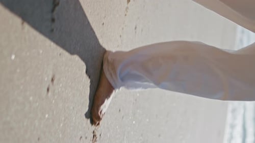 Couple Legs Stepping Sand Beach Leaving Footprints Vertical Oriented Closeup