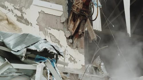 Excavator with Cutter Destroys Concrete Wall of Old Arena