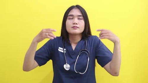 Young Asian doctor woman hold spreading hands in yoga om gesture relaxing meditating trying to calm