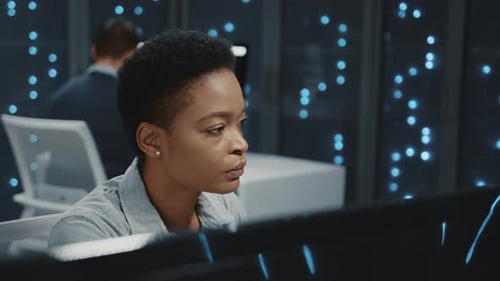 Woman Working at Computer in Futuristic Office Setting