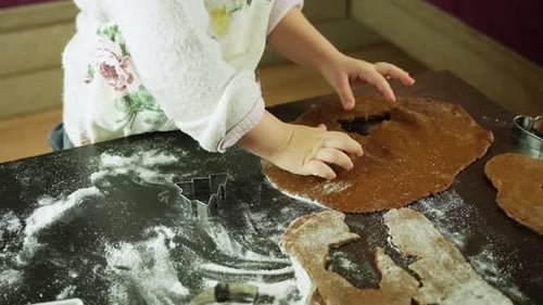 Child Making Christmas Cookies at Home