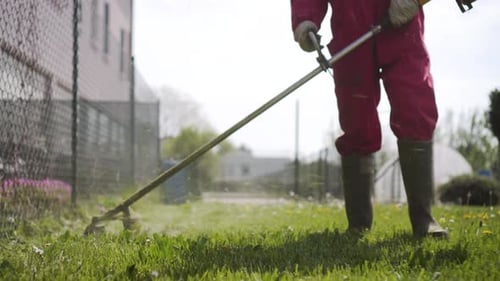 Trimming Grass with Gas Powered Weed Trimmer