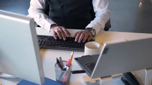 Businessman Working at Computer Typing on Keyboard at Office Desk 3034 Years