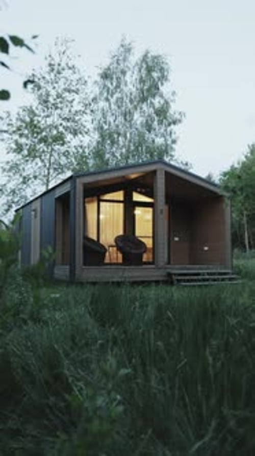 Cabin Exterior in Tall Grass at Night
