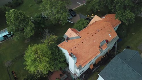 Roofers Installing a New Roof on an Residential Building Aerial Wide Footage