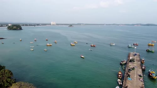 Orbit Shot Of Different Fishing Boats Anchored In Weligama harbor In Calm Blue Ocean, Sri Lanka