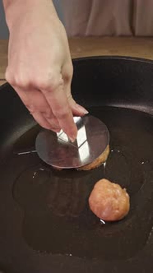 The Cook Uses a Burger Press to Flatten a Round Piece of Minced Meat Into a Patty