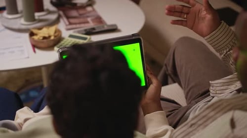 Man and Woman Using Tablet with Neon Green Screen