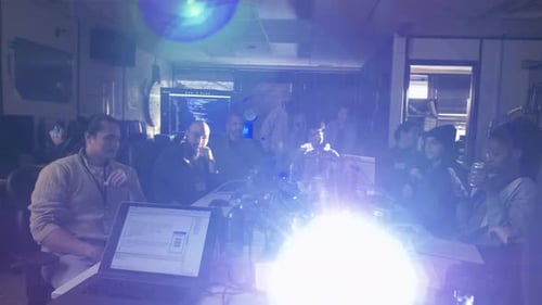 Hackers at Laptops Watching Presentation in Dark Office 2024 Years