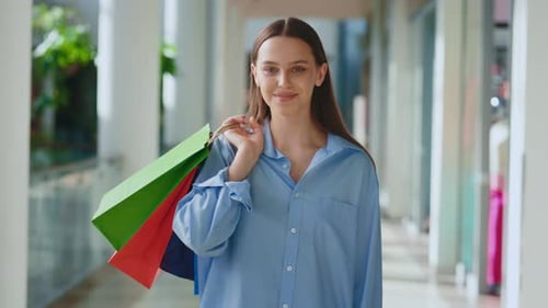 Young Woman Holding Shopping Bags in Retail Space