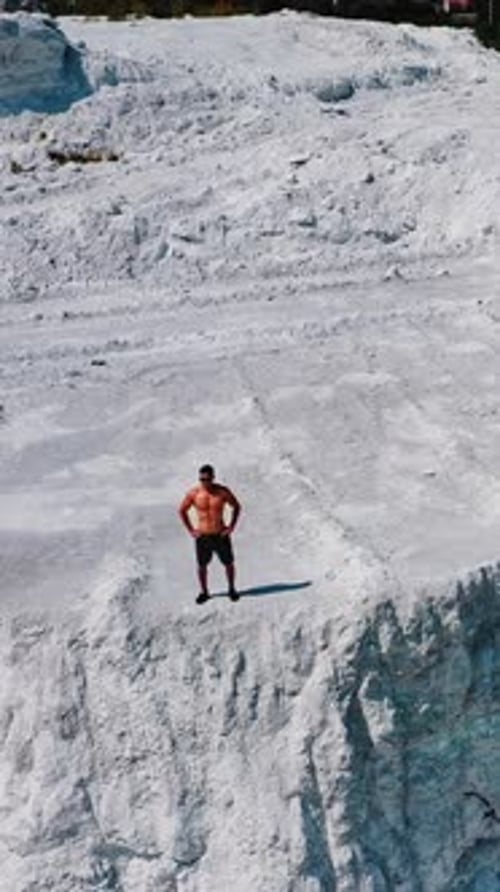 Man Posing on Rock Formation Aerial Shot