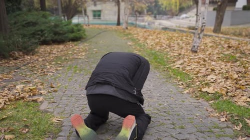The man with helpless and psychological problems is walking outdoors.