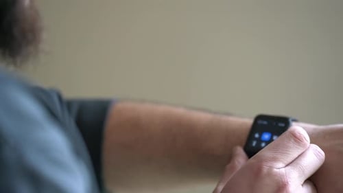 bearded man uses his smart watch 4k
