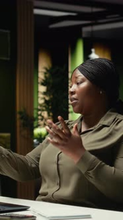 Woman Attending Online Meeting at Desk in Office
