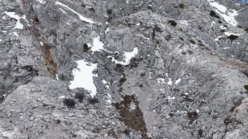 Mountain Rock Cliff Surface Close Up Wideangle Shot Drone Smoothly Rises Above the Dramatic Peaks of