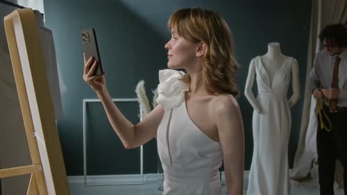 Jovem mulher tirando selfies no espelho na loja de noivas